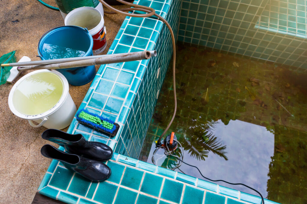 A dirty pool is being cleaned and inspected after a leak was neglected